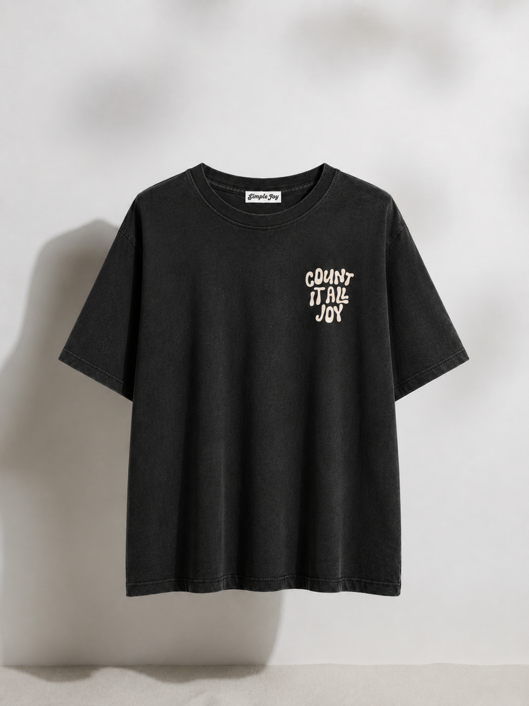 Black t-shirt with white text on a light gray background
