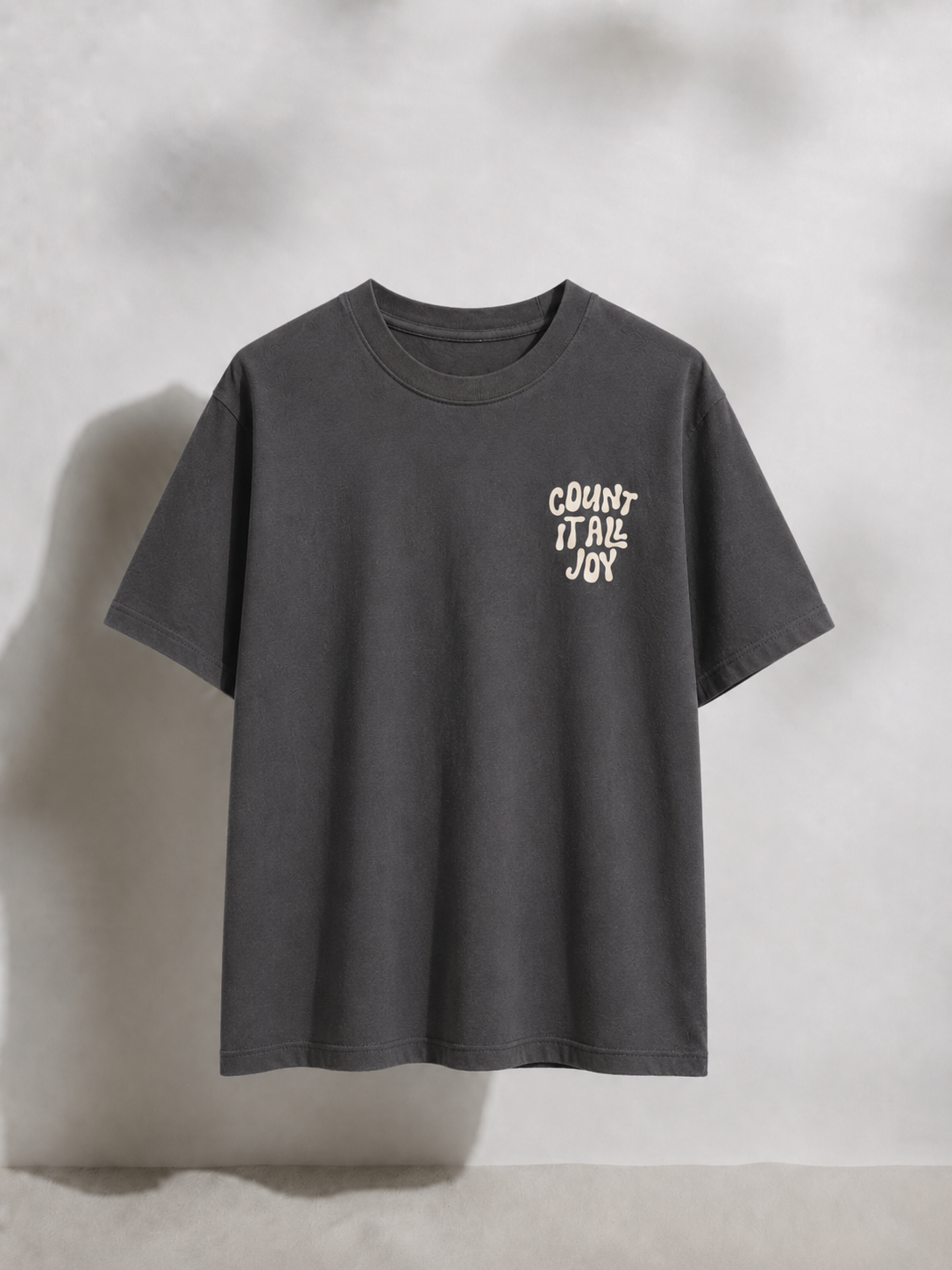 Gray t-shirt with white text on a light gray background