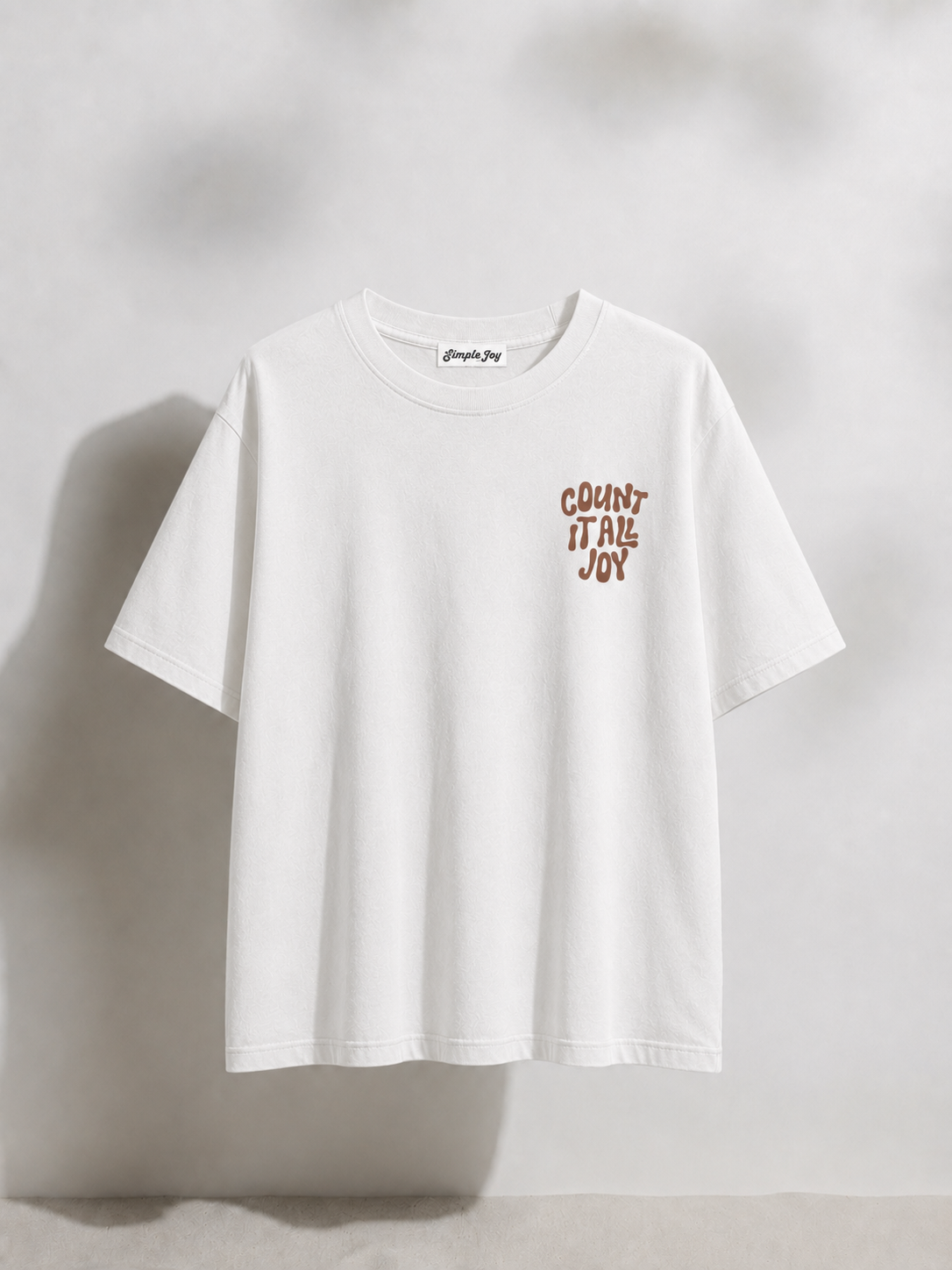White t-shirt with text on a light gray background