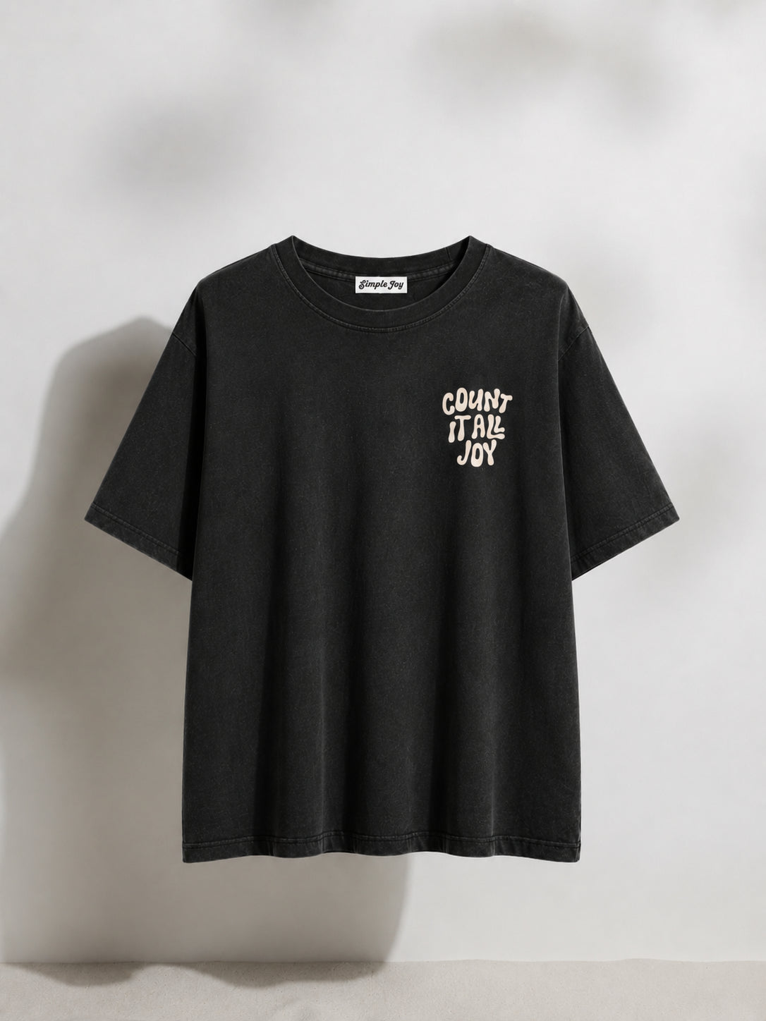 Black t-shirt with white text on a light gray background