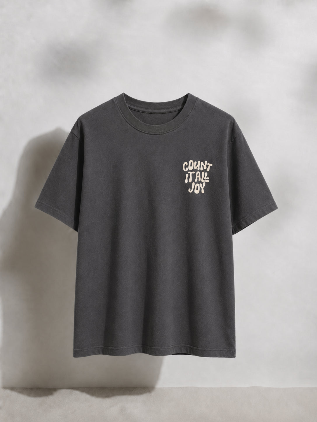 Gray t-shirt with white text on a light gray background